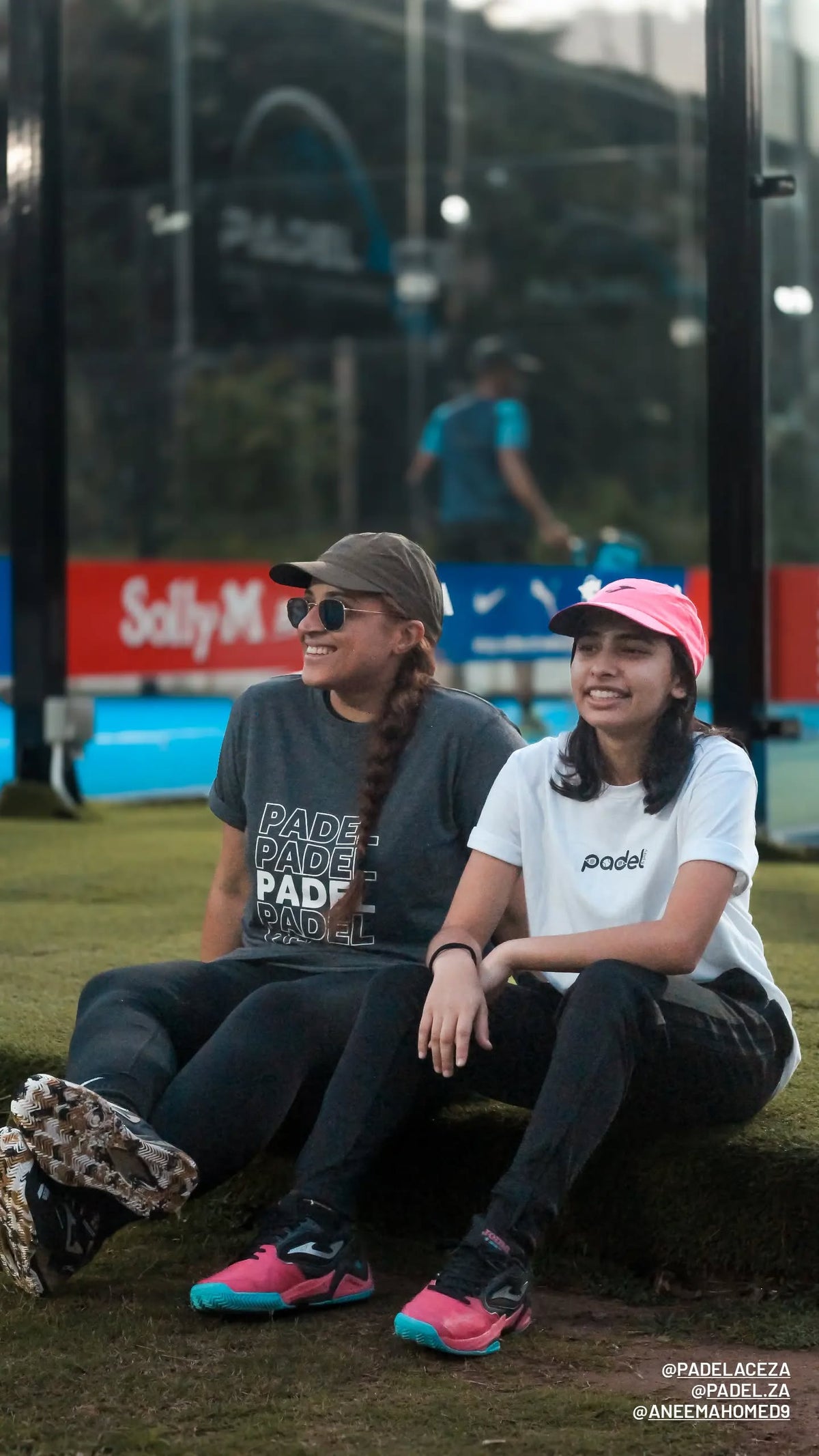 Two friends wearing Zazu shirts courtside