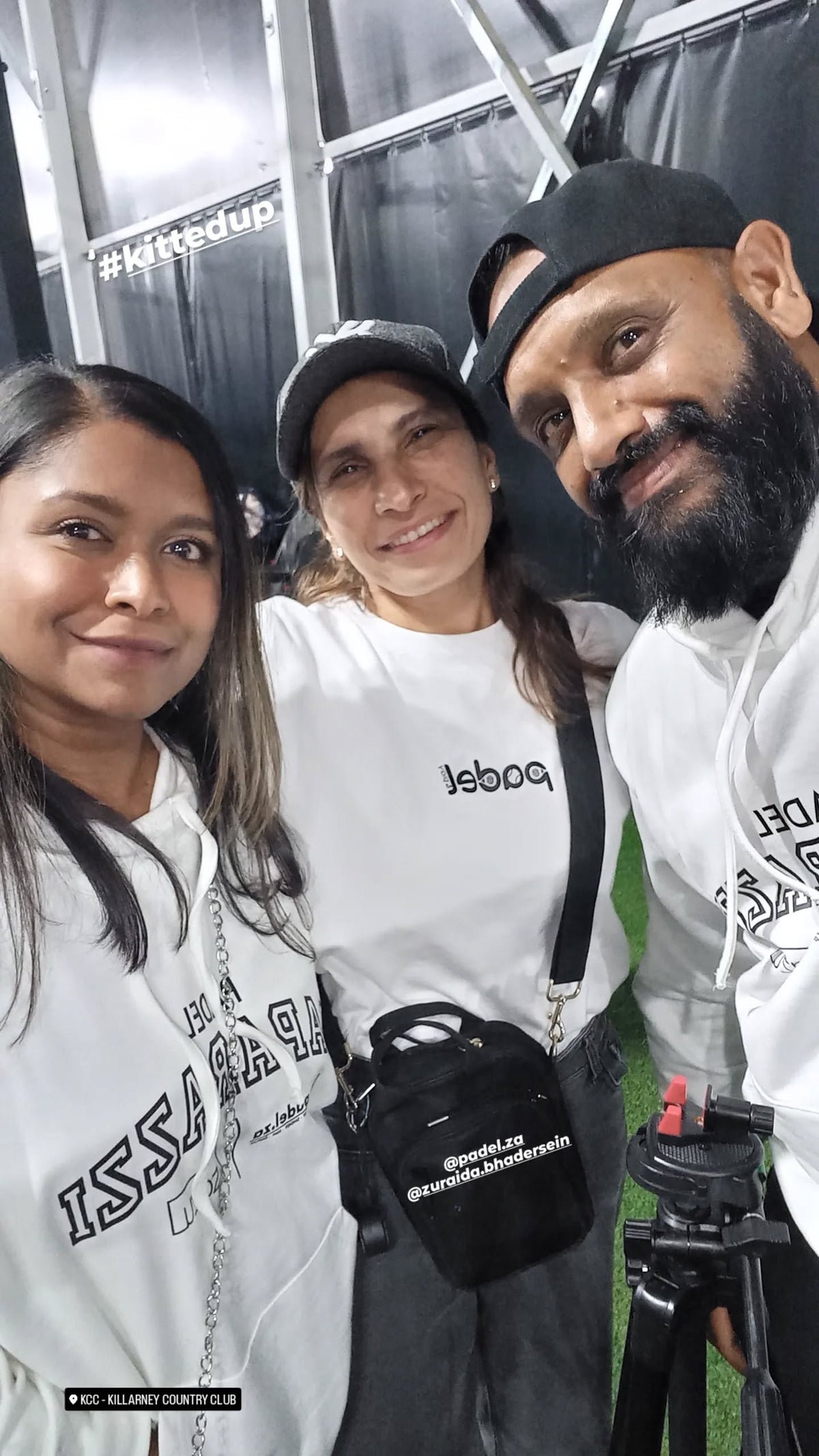 Three members of the Zazu padel community in white hoodies